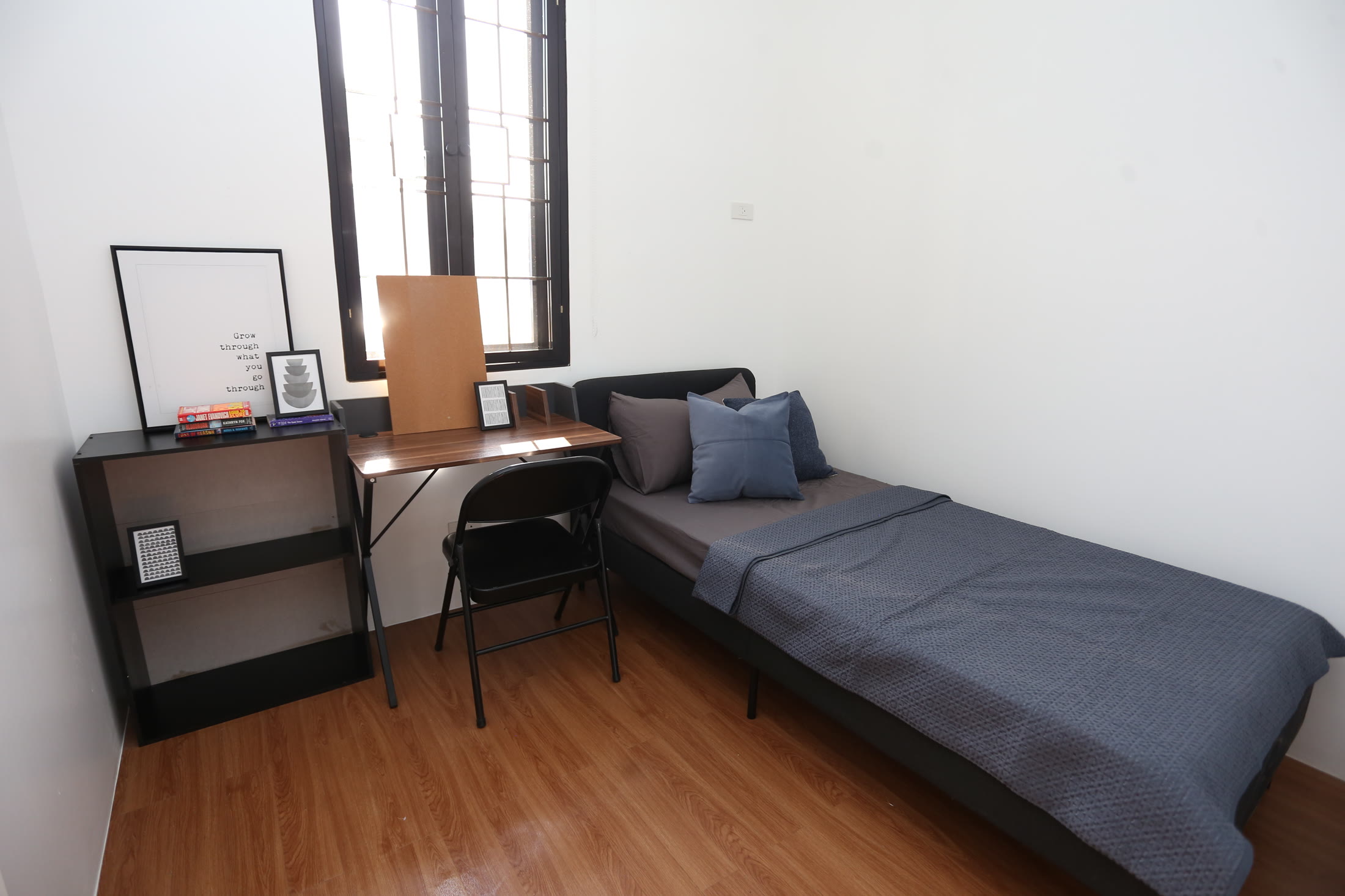 Levana bedroom styled with a study desk and charcoal bedding