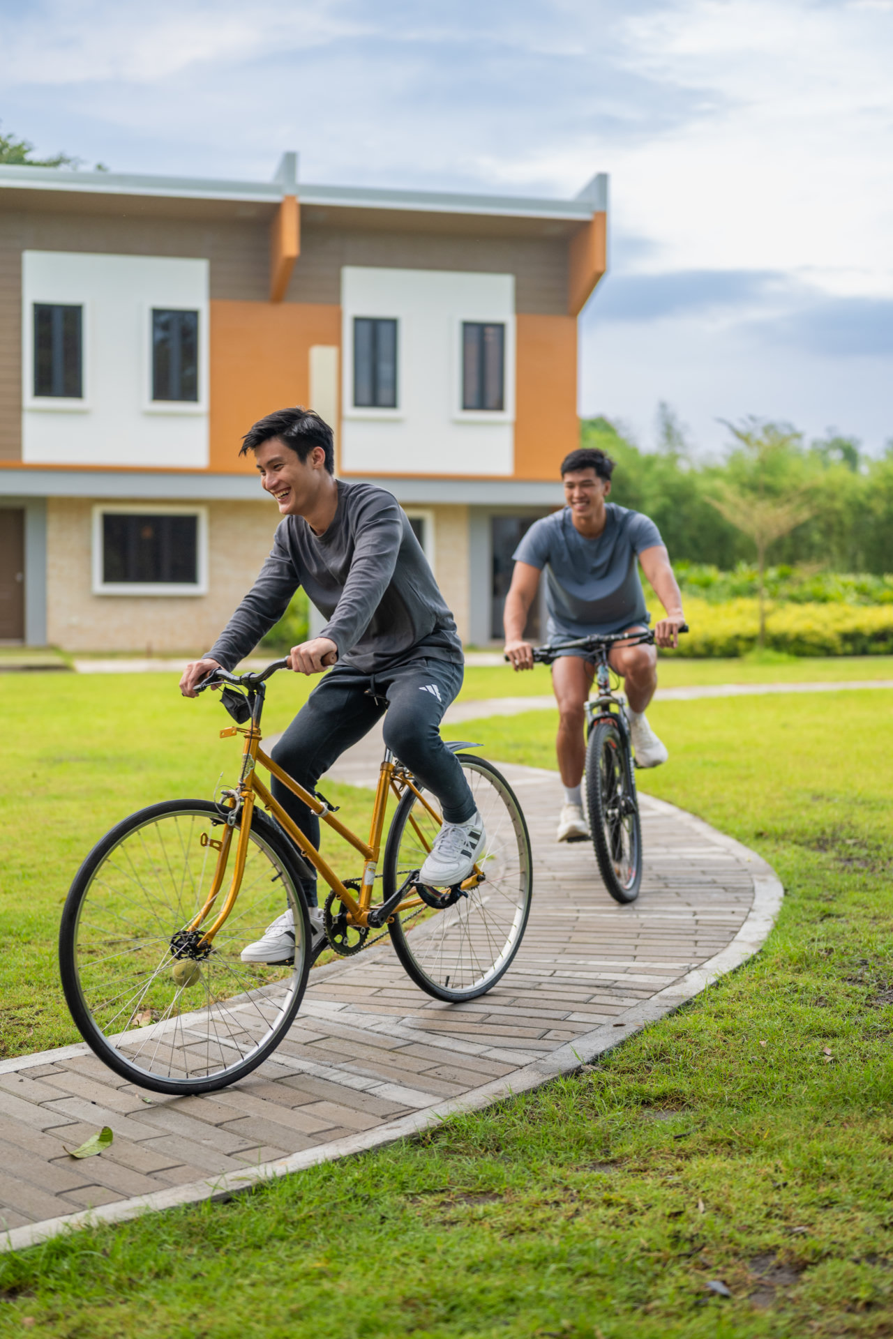 Residents cycling along a landscaped path in Paseo de Lipa