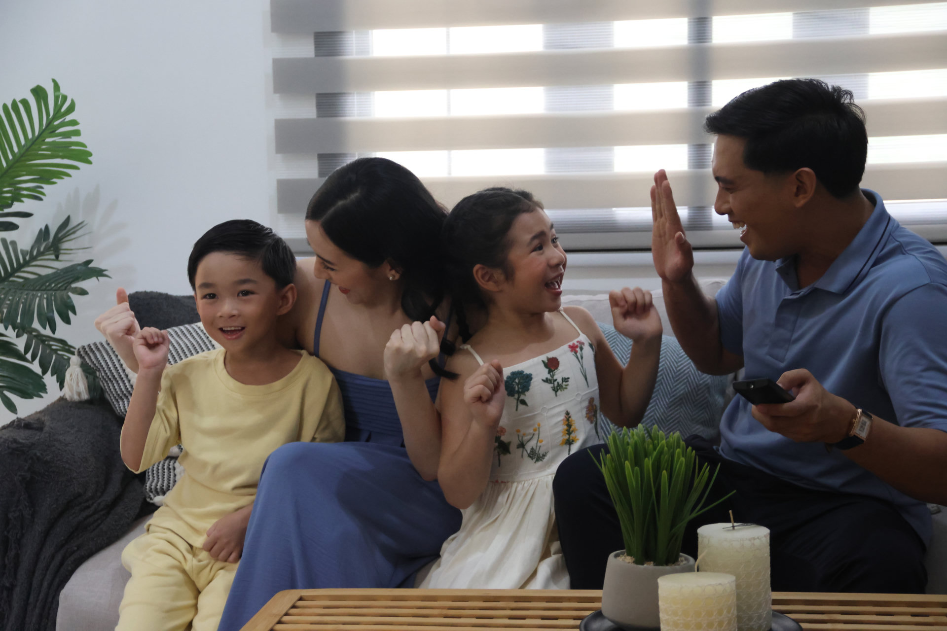A family laughing together in their living room