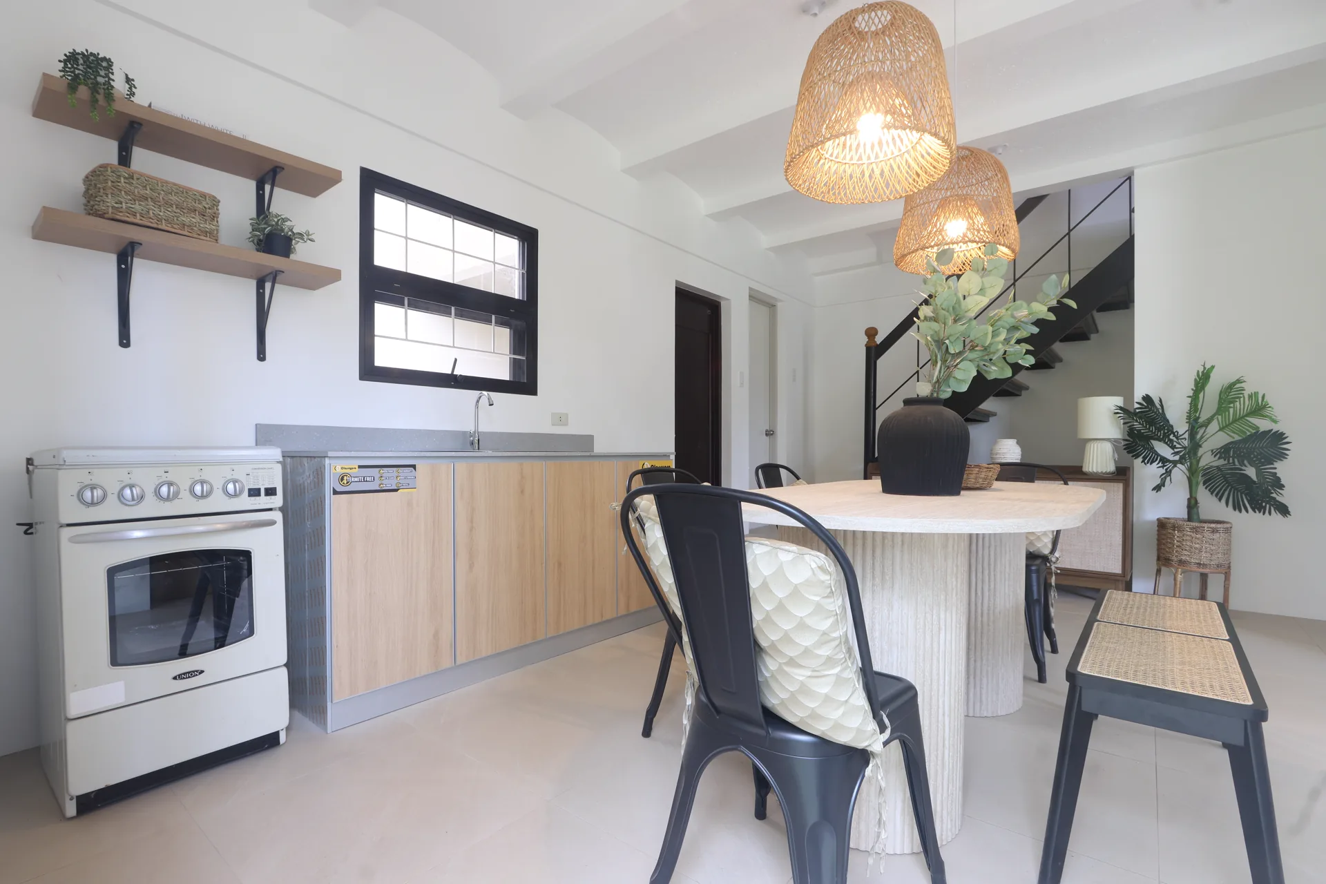 Larissa kitchen and dining room with woven pendant lights and light timber cabinetry